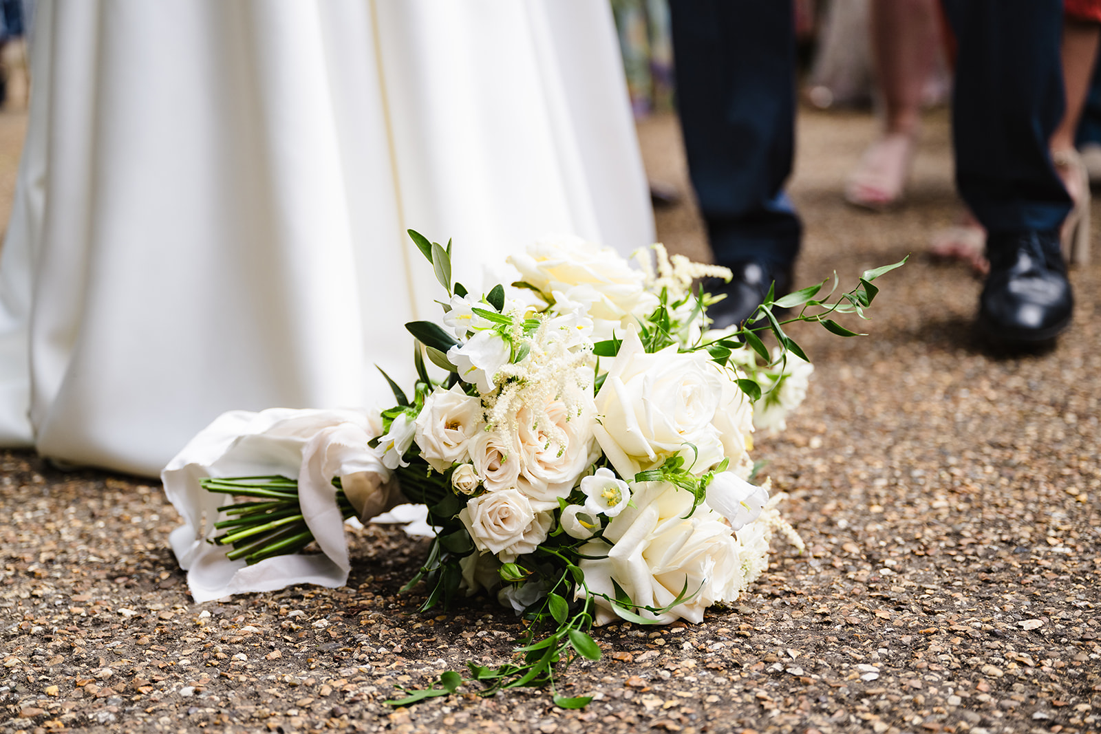 Brides flowers resting at her feet during her stapleford park wedding by Amanda Forman Photography