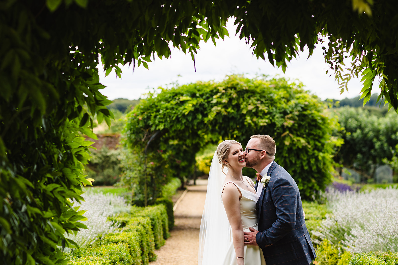 wedding day portrait of bride and groom kissing at Stapleford park by Amanda Forman Photography