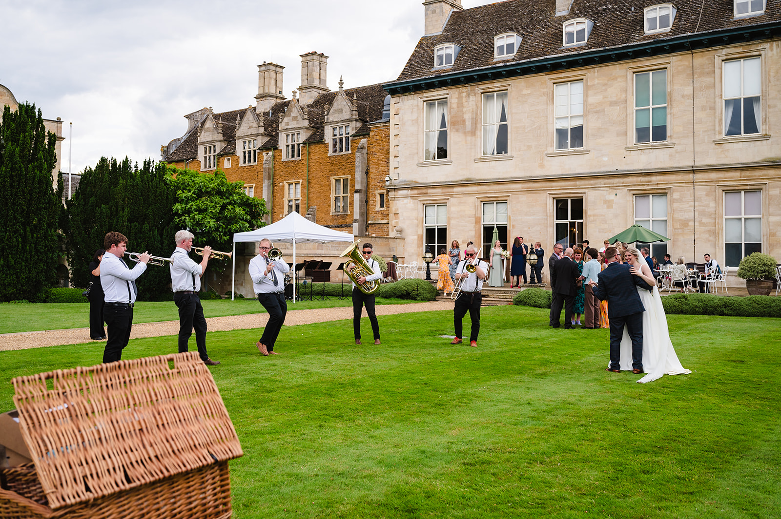 Bride and groom dancing to their brass band in the grounds of stapleford park by Amanda Forman Photography