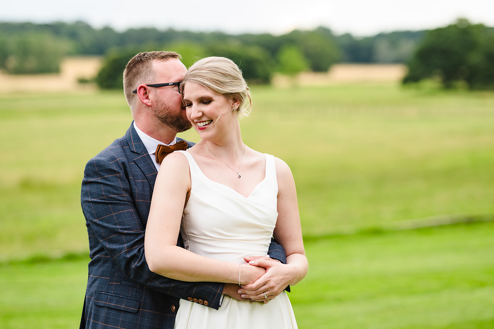 Bride and groom embracing during their wedding photos at Stapleford park by Amanda Forman Photography