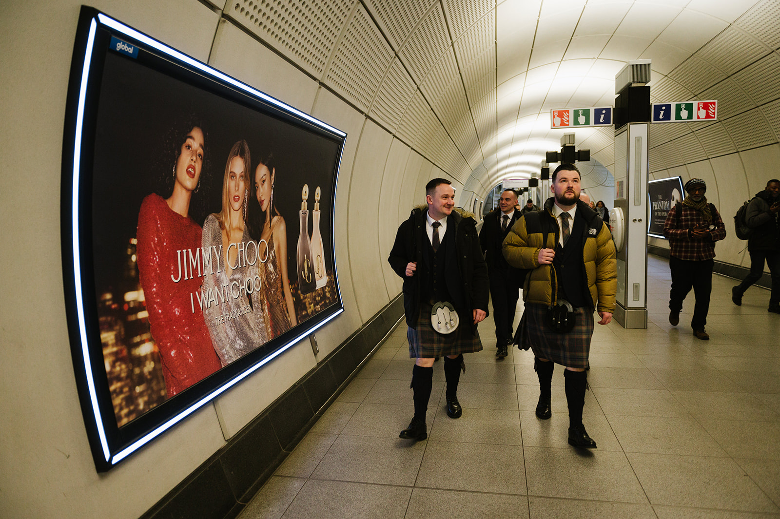 Groom and his ushers walking through the tube in London