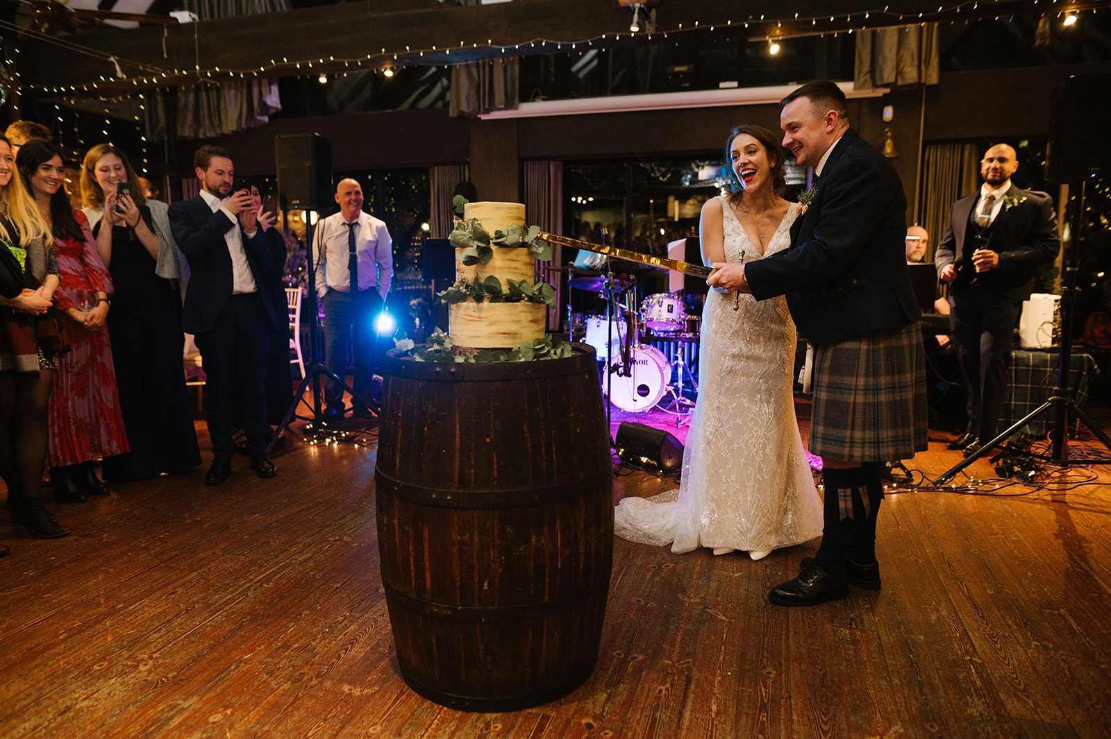 The bride and groom cut the cake at the Dickens Inn Central London Wedding