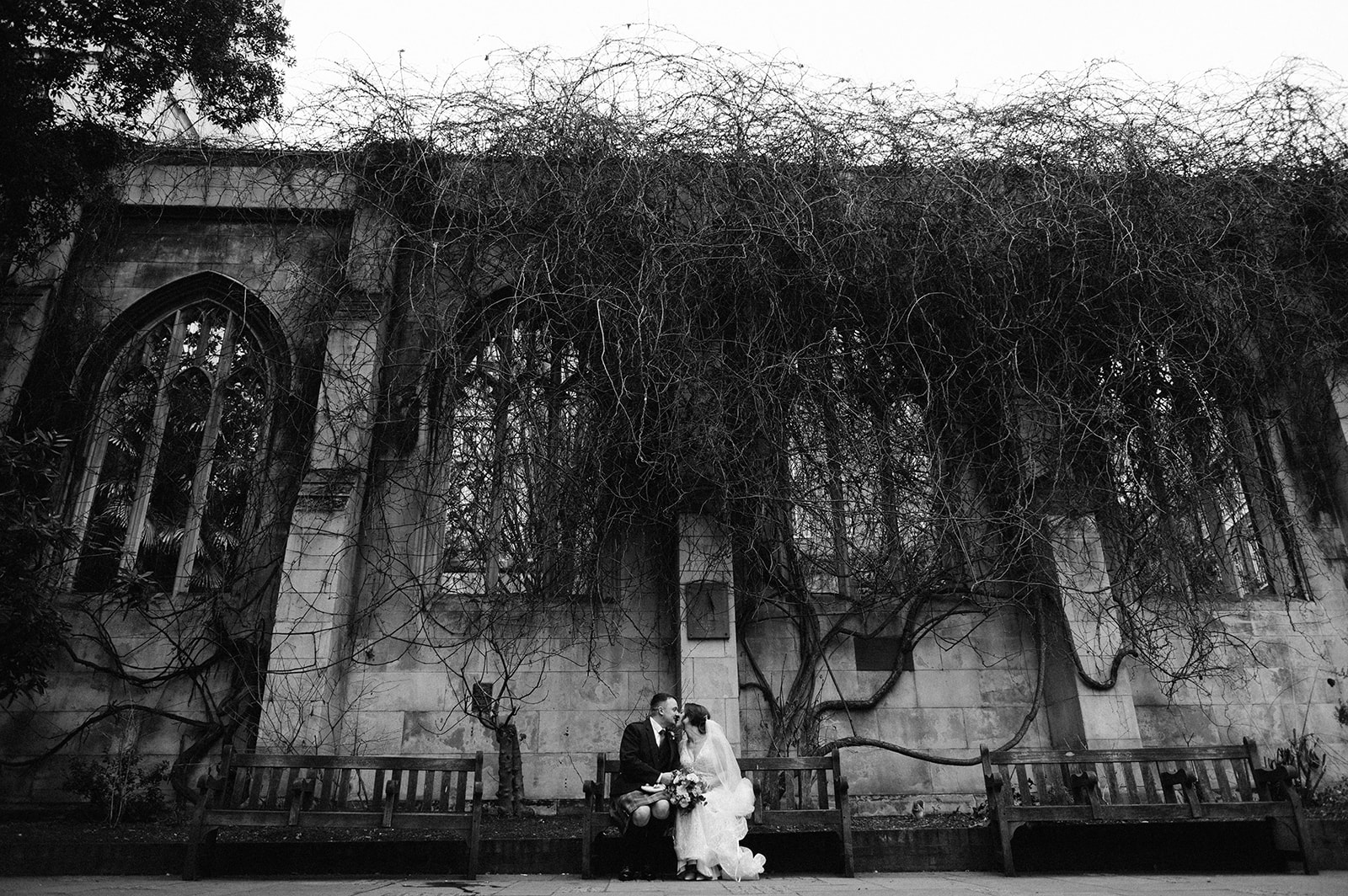 The bride and groom at St Dunstan East Church ruins in London on their wedding day