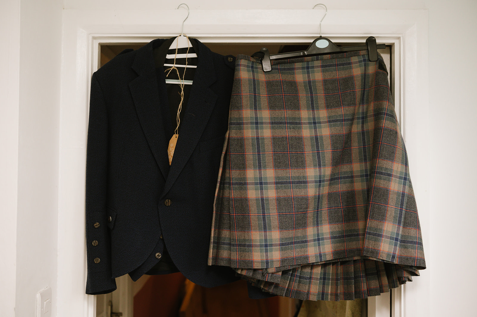 The groom's kilt hanging up next to his jacket