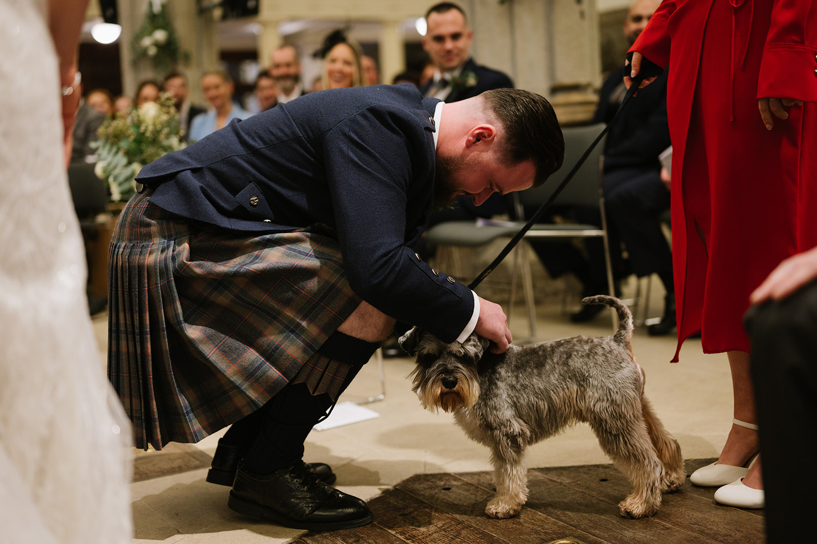 Their dog brings the wedding rings during the ceremony at St Helen's Church Bishopsgate