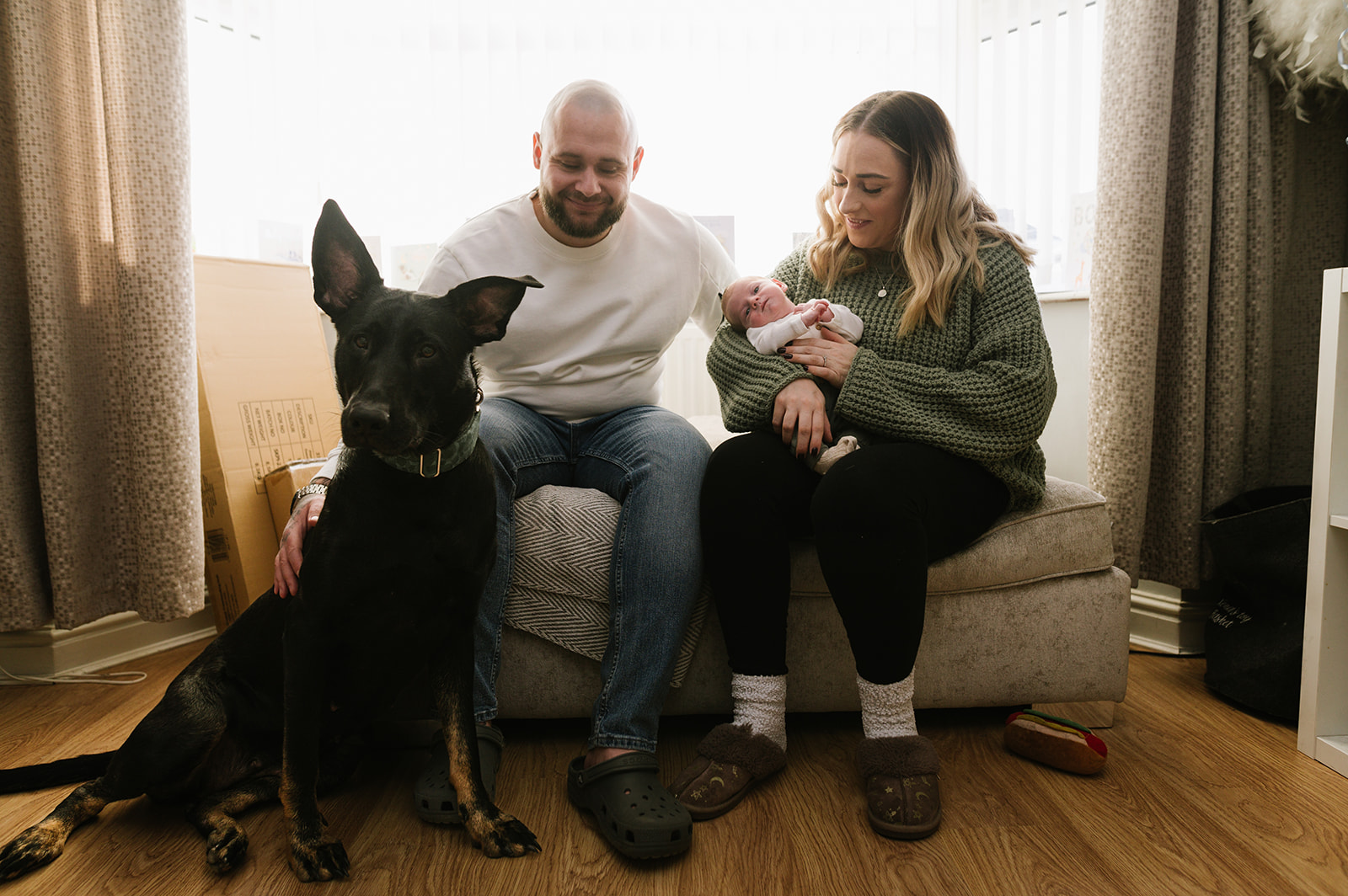 Newborn baby boy with his parents and dog
