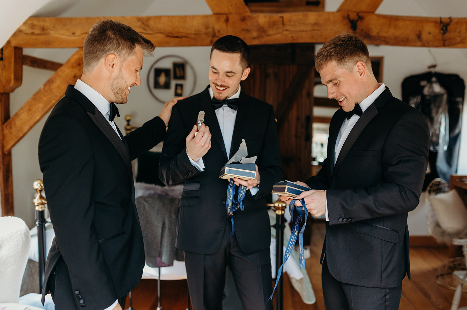 Groom and groomsmen exchanging gift before the wedding ceremony in Hampshire.
