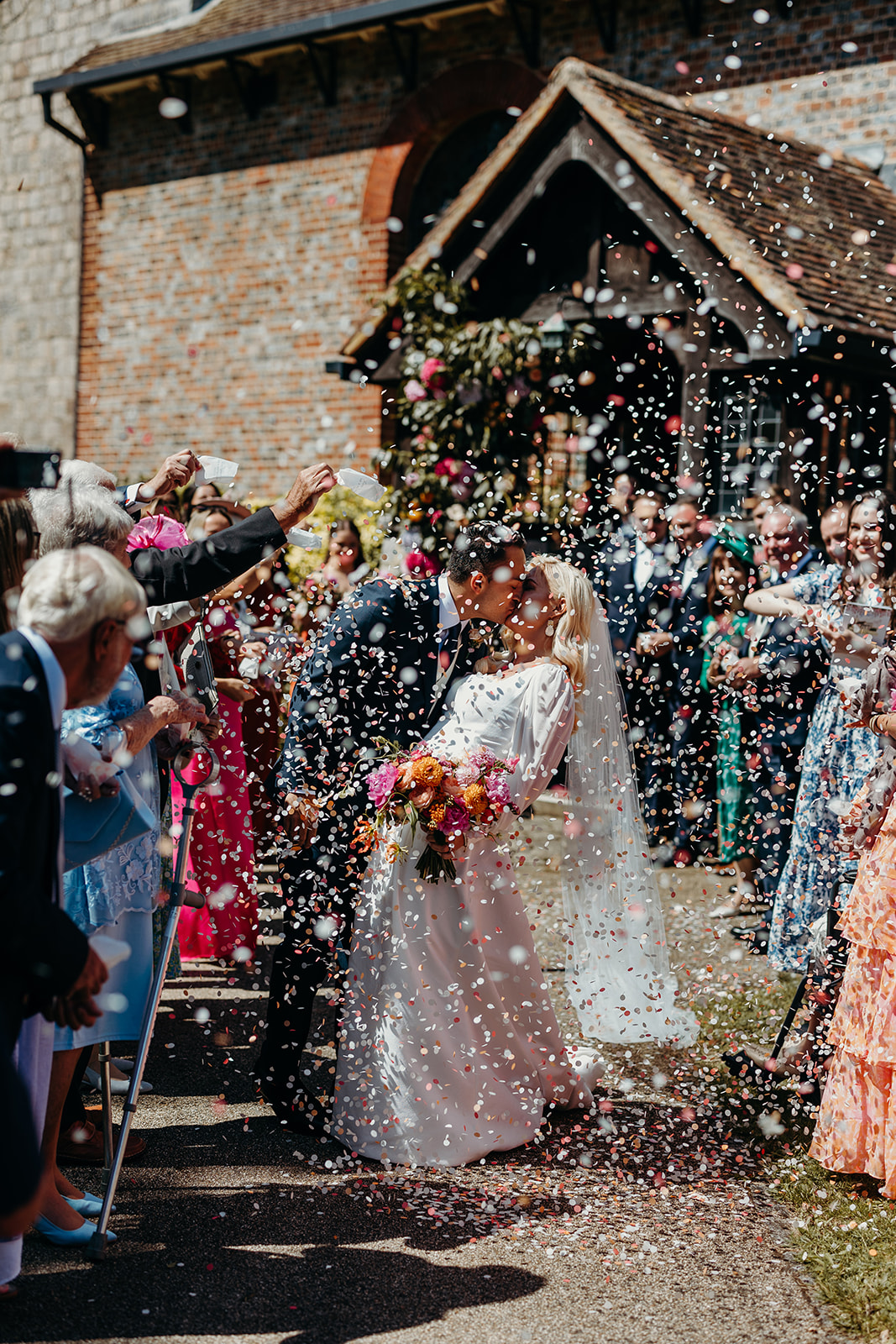 confetti covering bride and groom