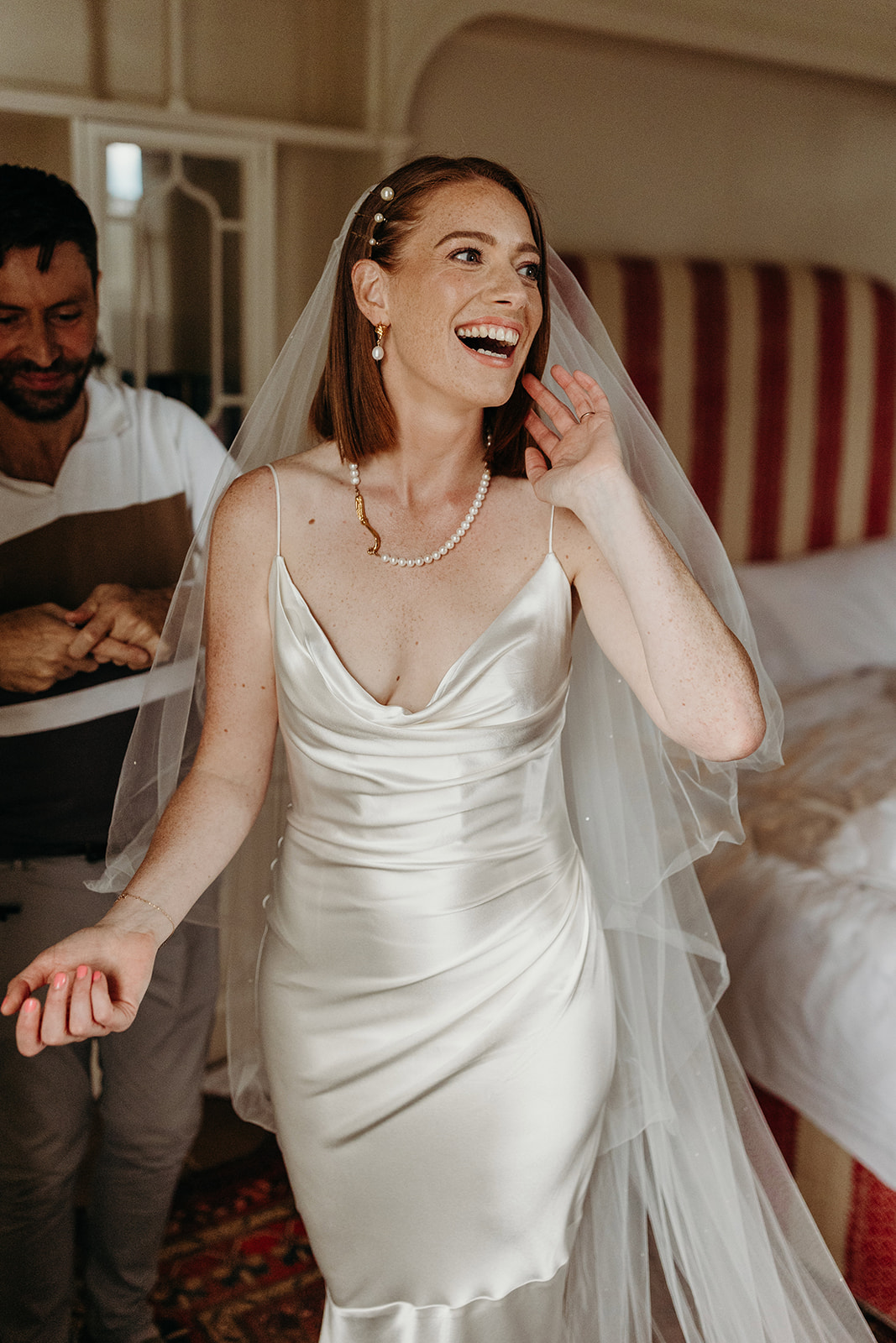 bride smiling after getting into her wedding dress