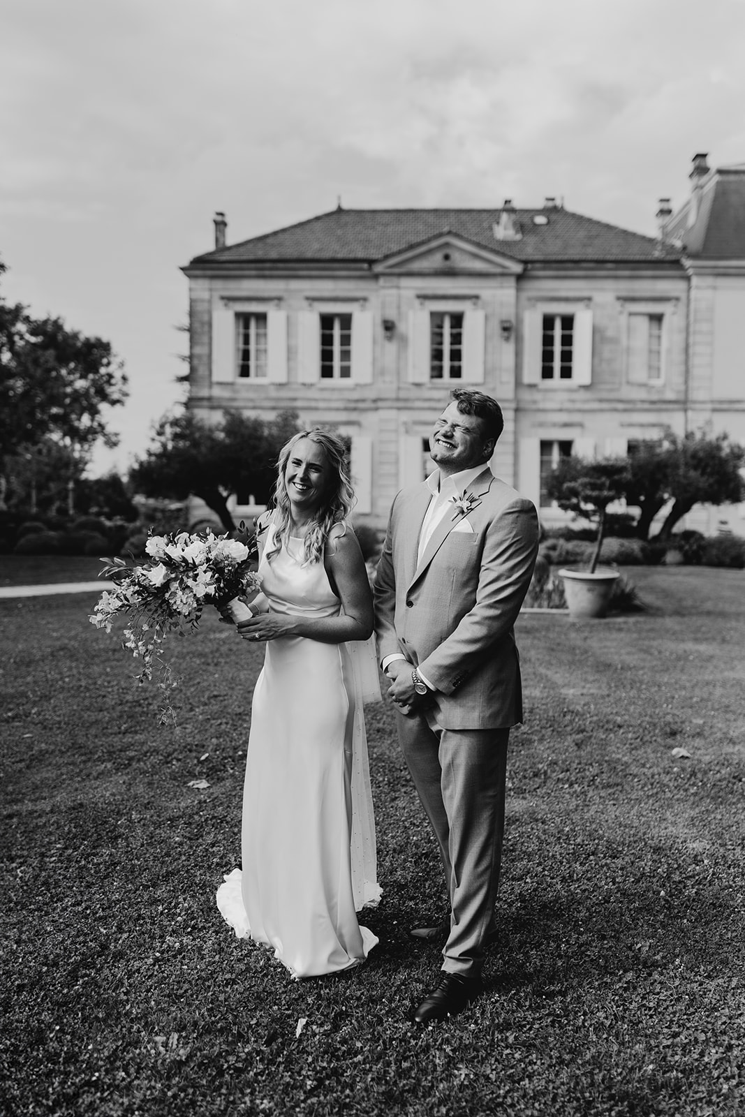 Bride and groom pose photographs at chateau wedding near Bordeaux