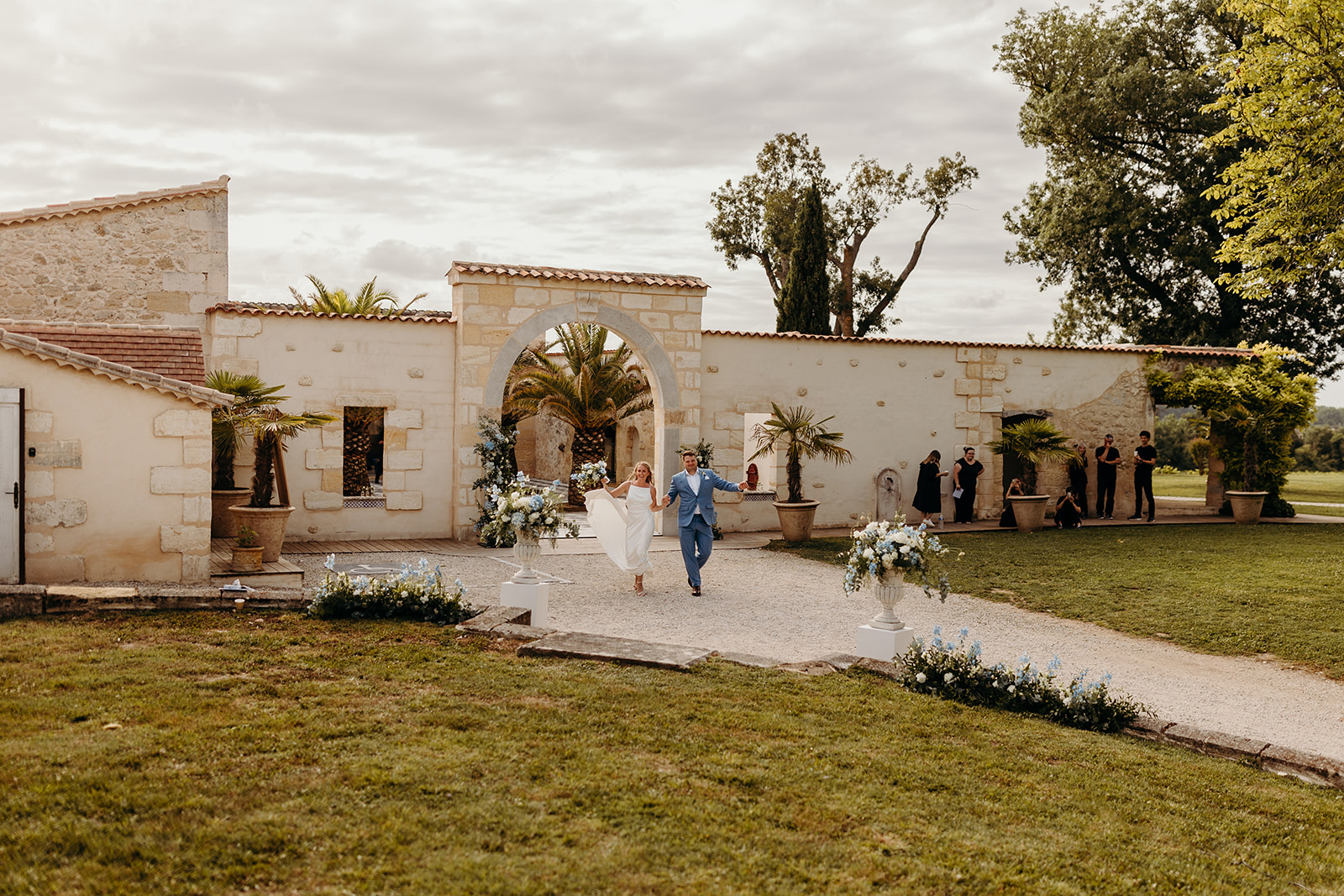 newly weds make entrance to outdoor dinner at Chateau de Garde wedding