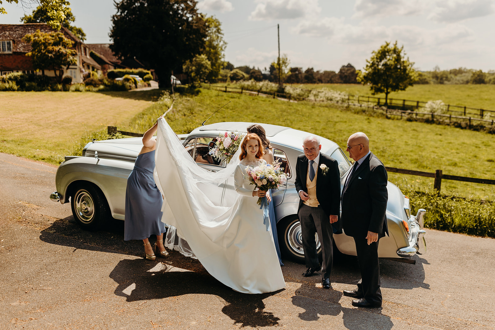 bride arrives in vintage car at church wedding 