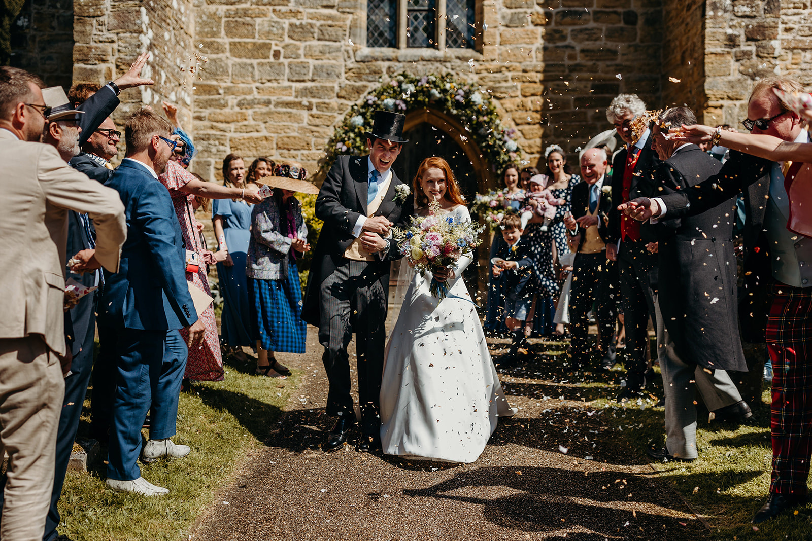 bride and groom get confetti thrown at them at East Sussex wedding 