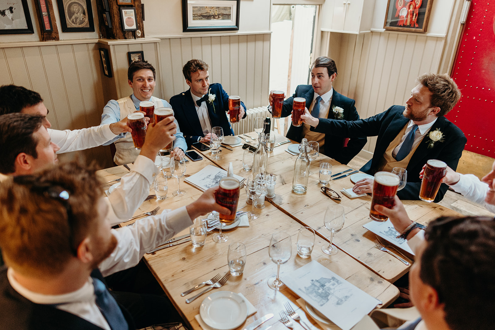 Groom and groomsmen enjoying a pint at a local East Sussex pub before the wedding.