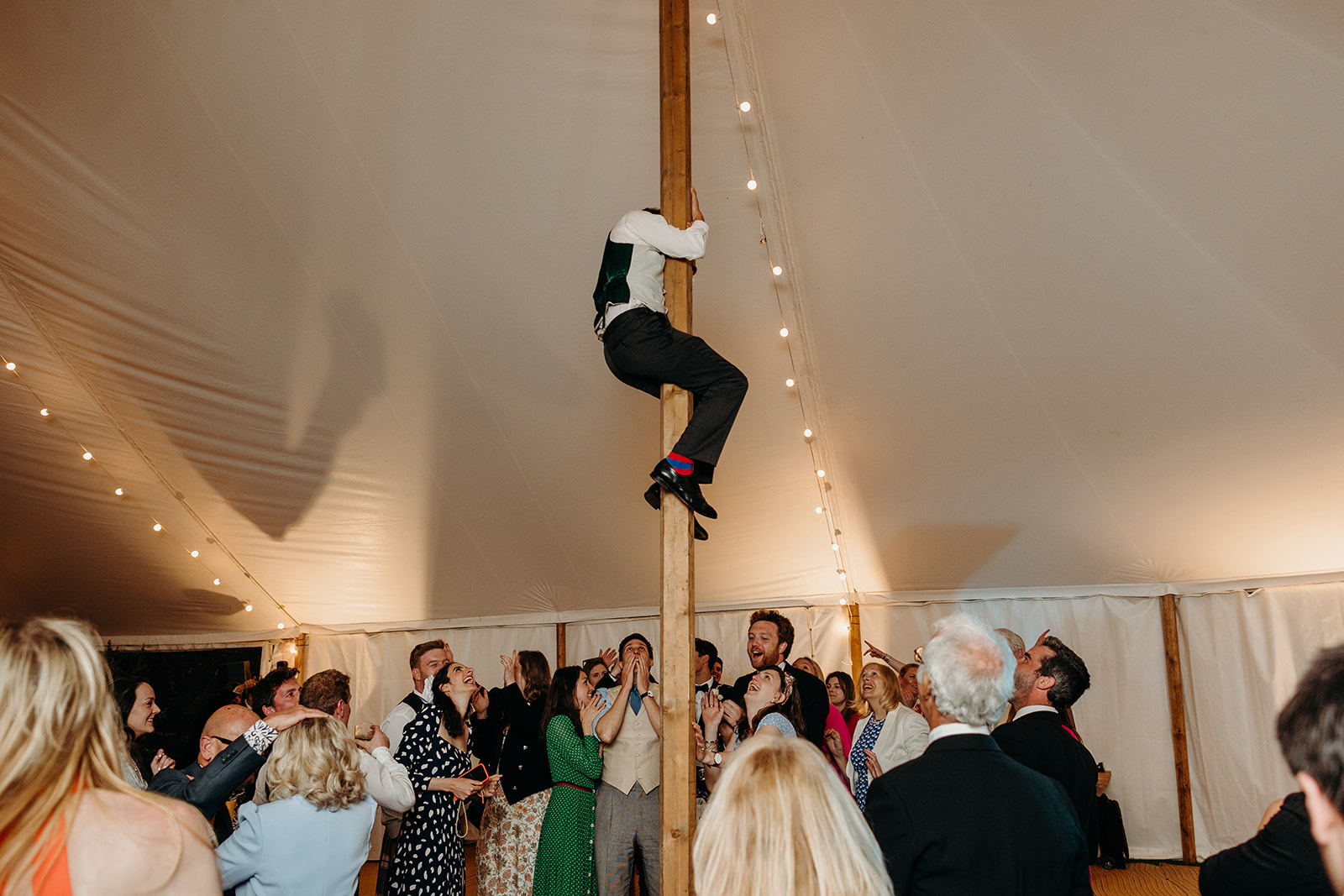 Guests scaling the marquee poles in a display of revelry at the East Sussex wedding.