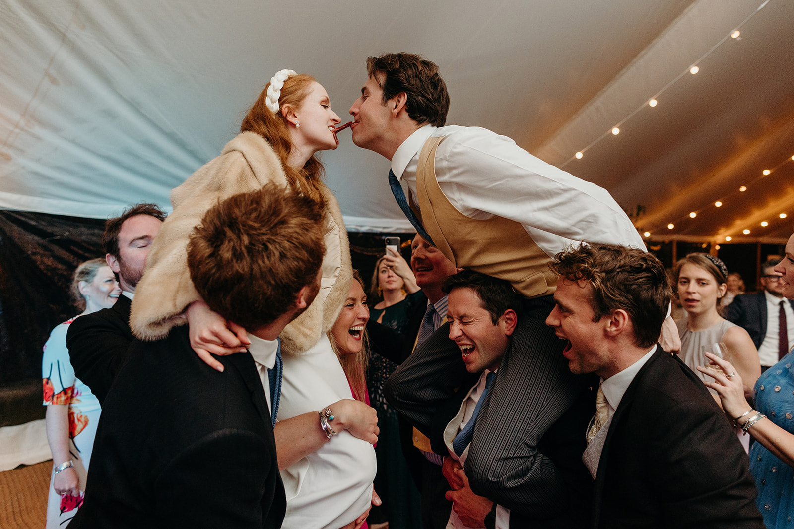 The groom's spirited foray atop shoulders during the East Sussex wedding celebrations.