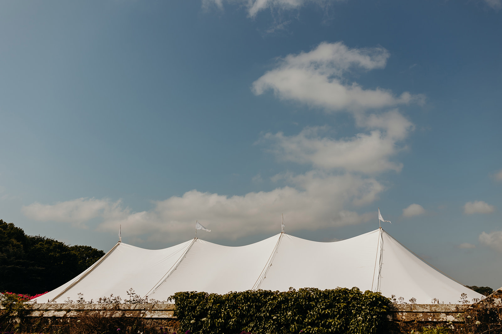 Large wedding marquee with blue sky and clouds in the background