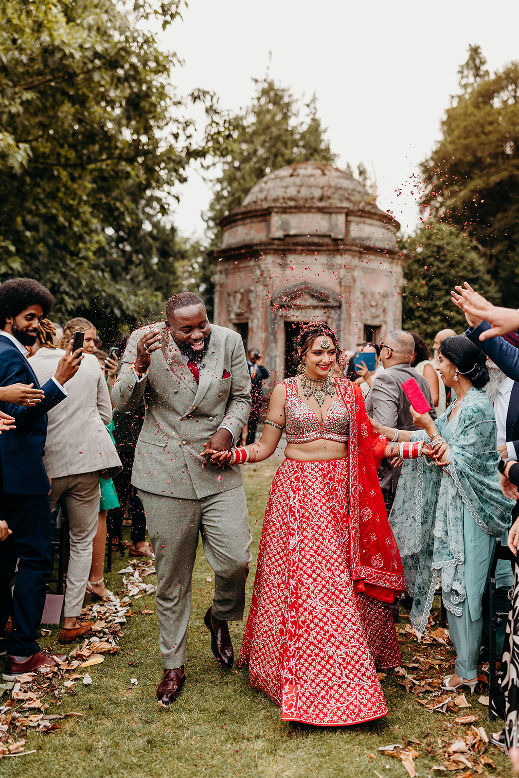 Indian bride and Ghanian groom being showered with confetti at Dorset wedding 