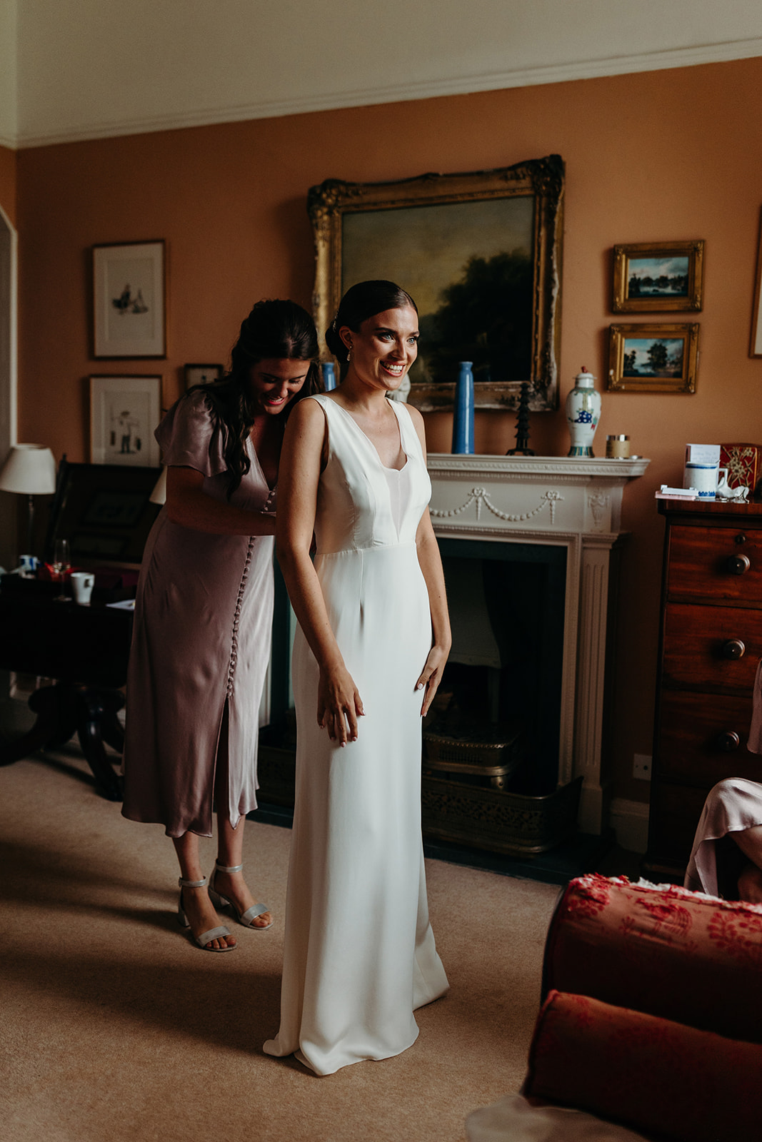 bride getting in dress at lake district house wedding