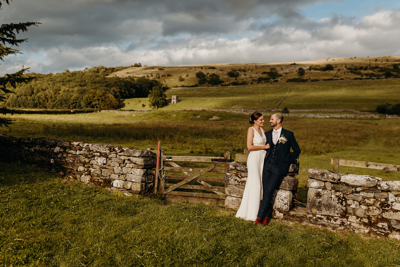 bride and groom pose for photographs at Longlands in Cartmel