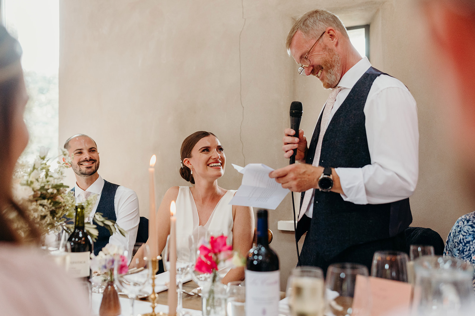 father of bride does speech as bride looks at him