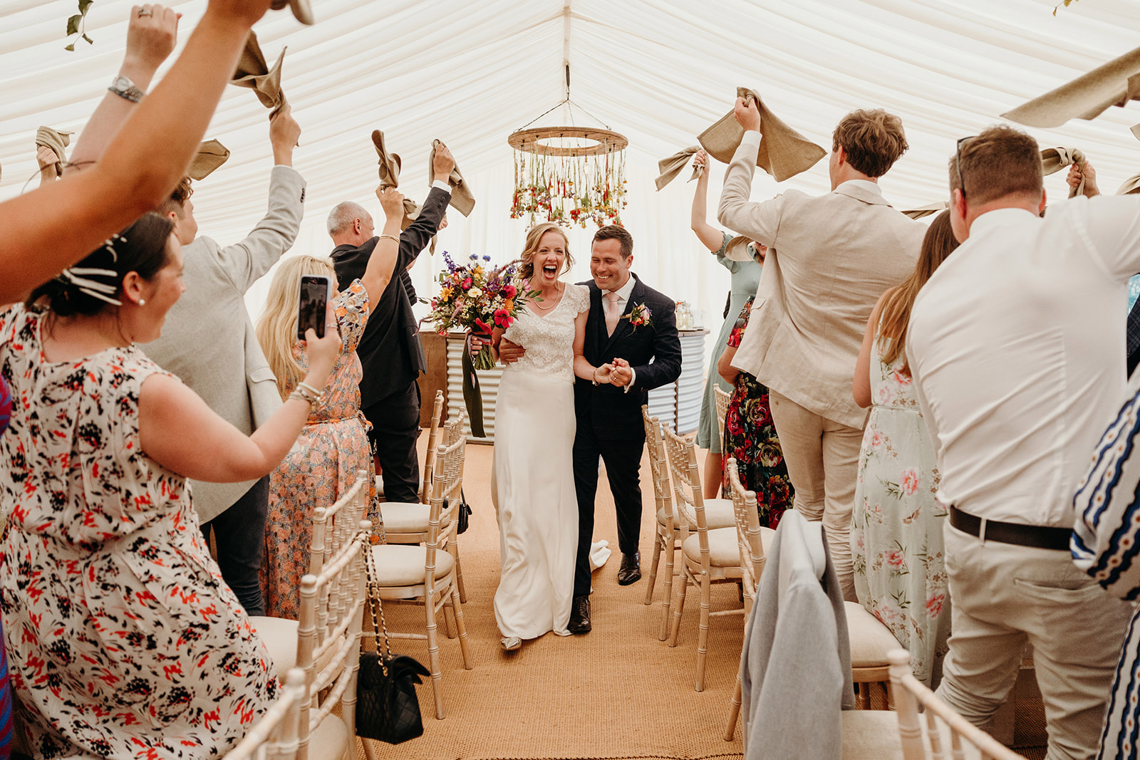 bride and groom dance as they enter Dorset marquee wedding reception