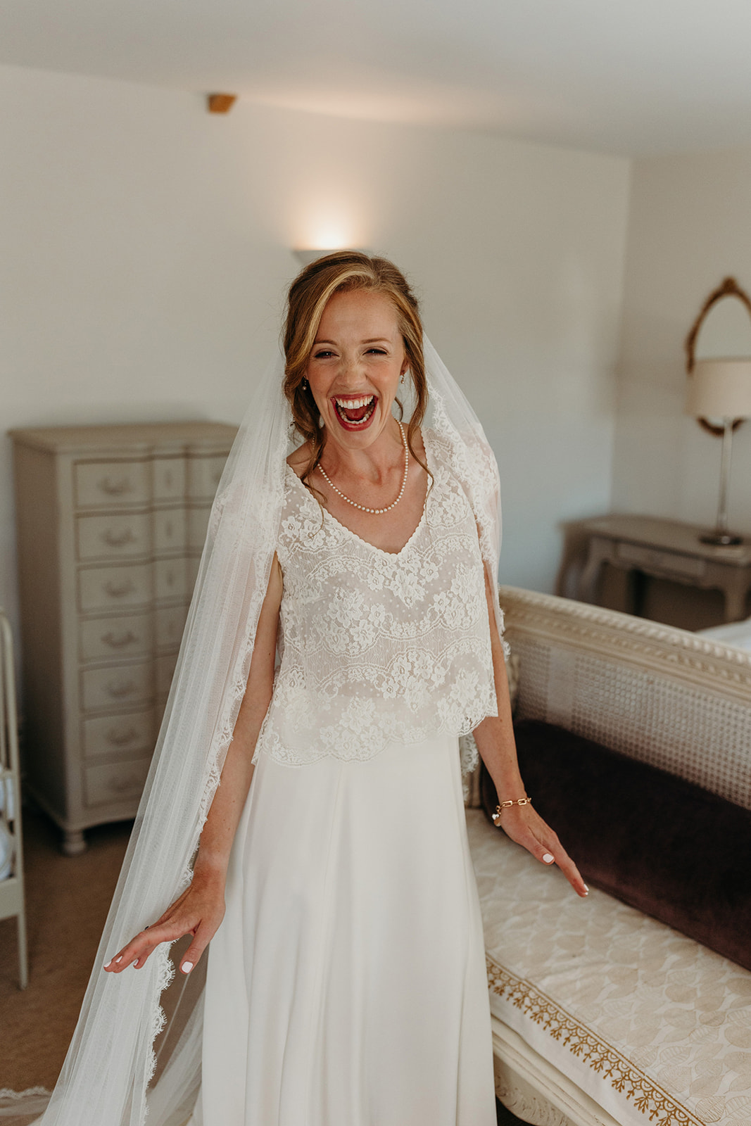 bride smiling getting into her wedding dress