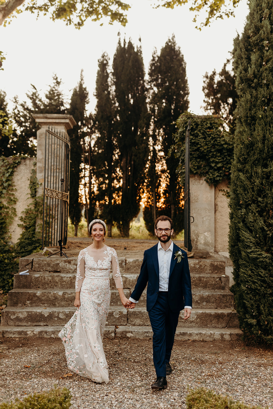 Couple walk down stairs at destination wedding in French chateau