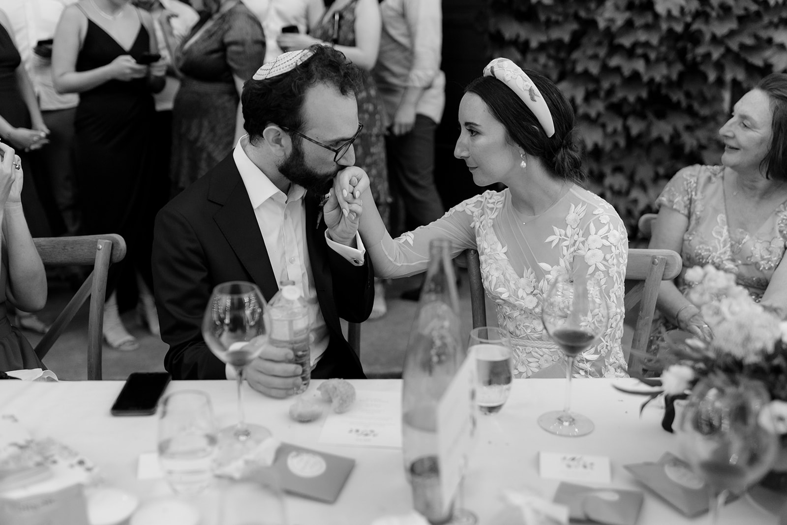 Groom kisses brides hand after his wedding speech