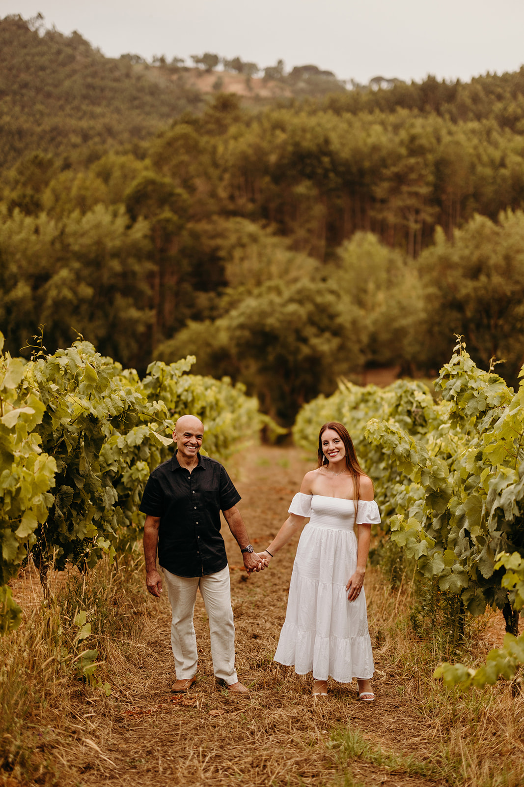 bride and groom walking down Portugal vineyard