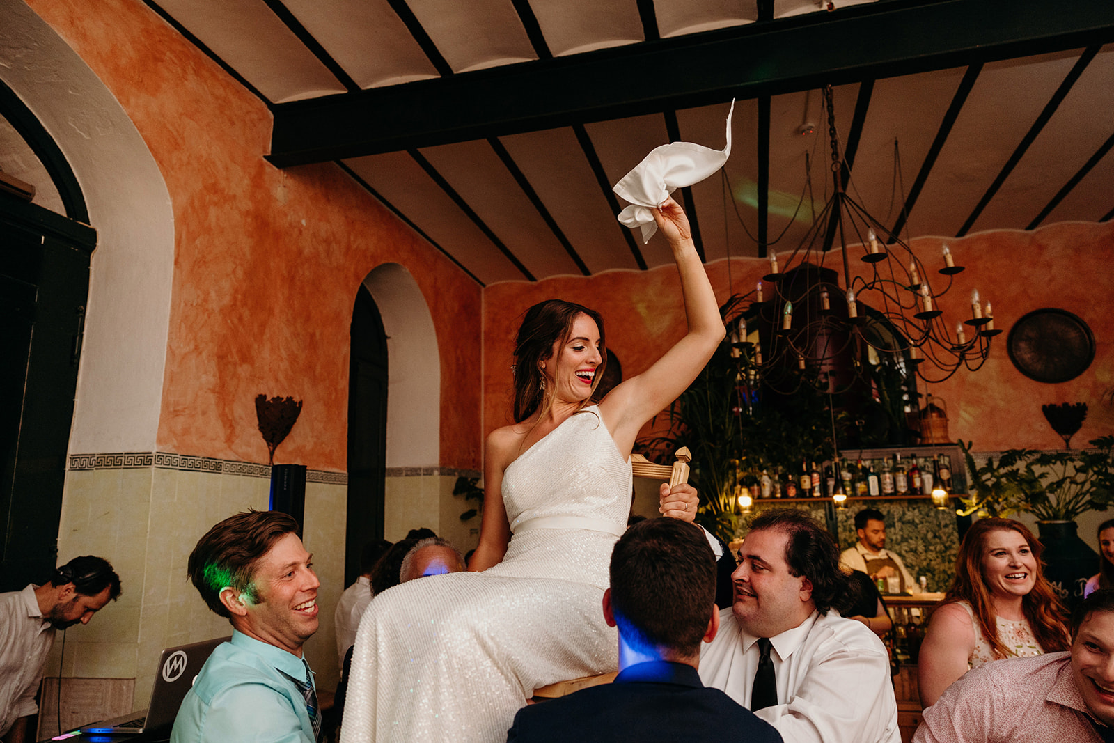 bride is lifted in the air by wedding guests at Portugal destination wedding
