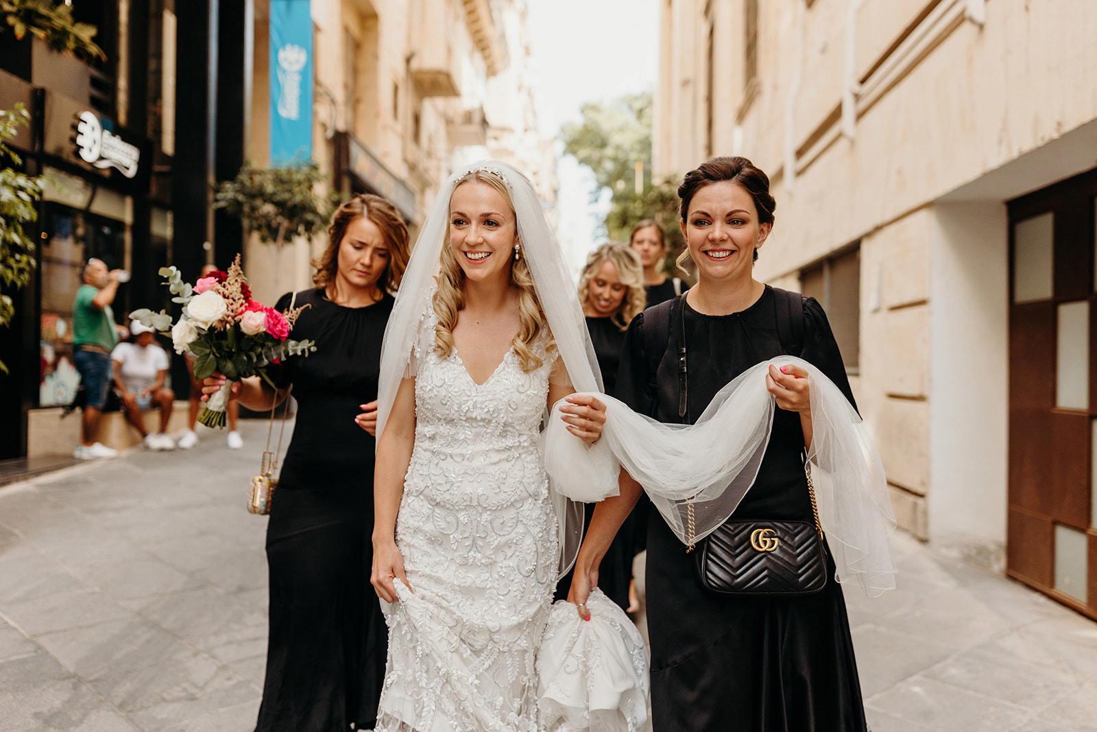 Bride walks with Bridesmaids down street in Valletta