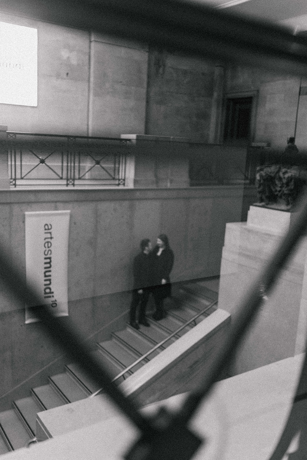 couple walking up a staircase in a museum