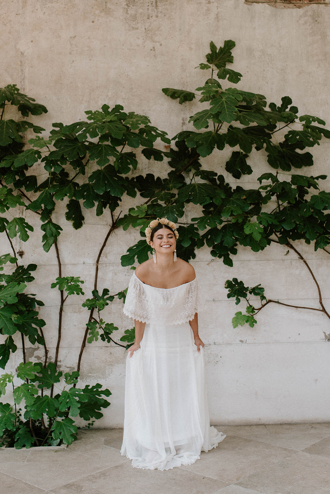 bride standing in fig house against greenery wall in fig house at Middleton lodge