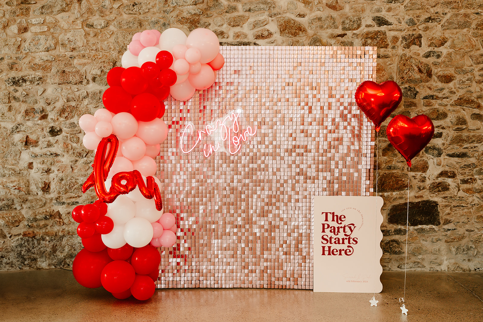 aberdeen prop hire backdrop sequin pink on brick wall with red balloons