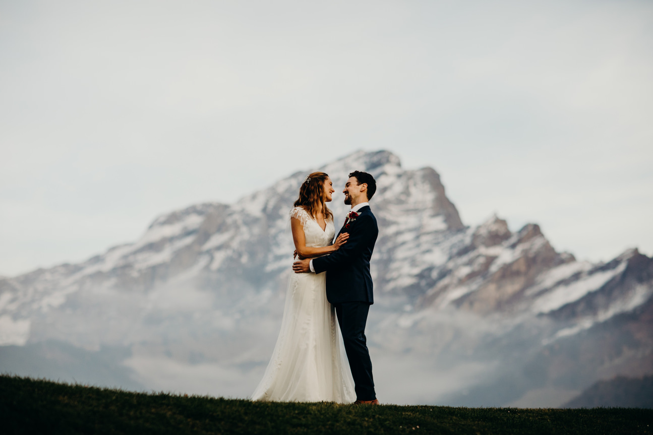 bride and groom get close with swiss mountains 