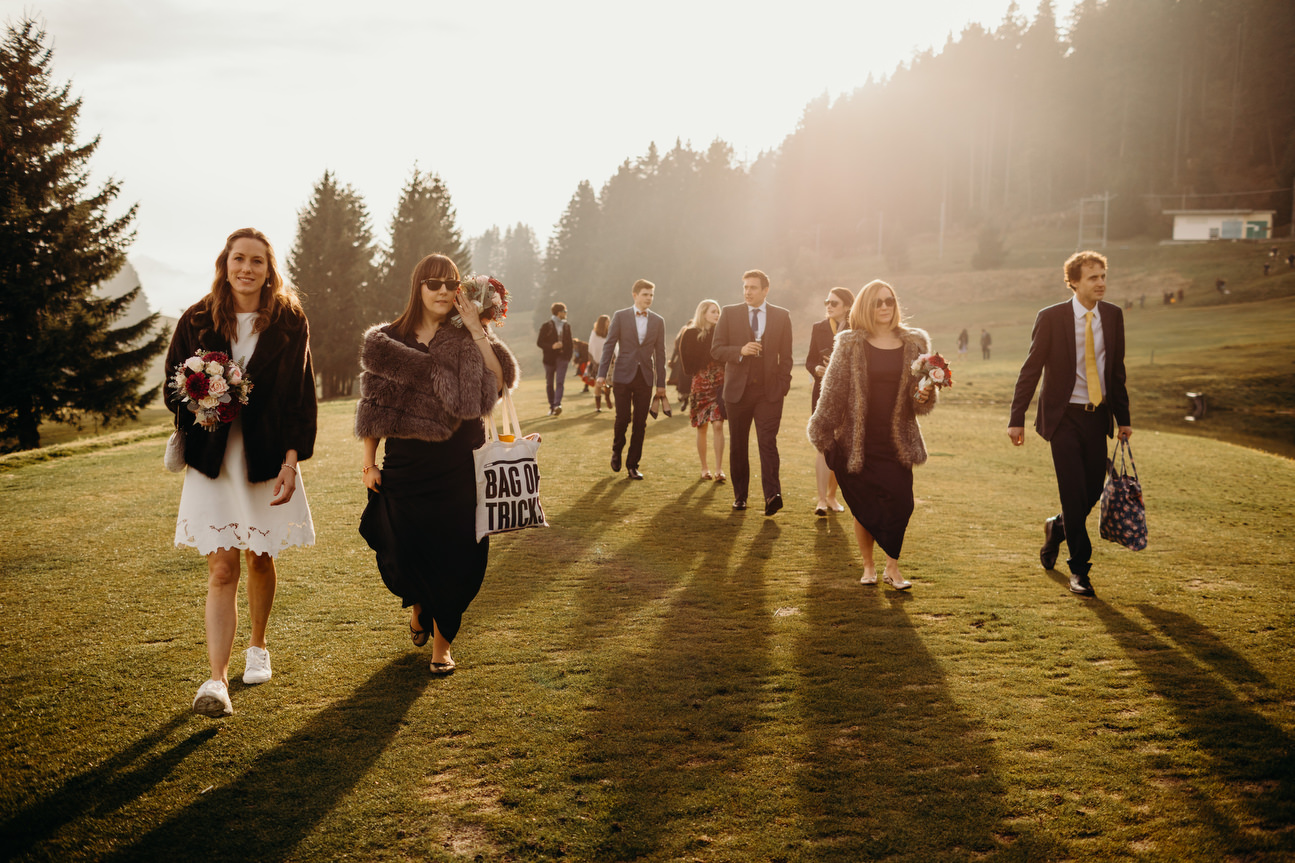 guest arriving at swiss alps wedding with sun behind casting their shadows ahead