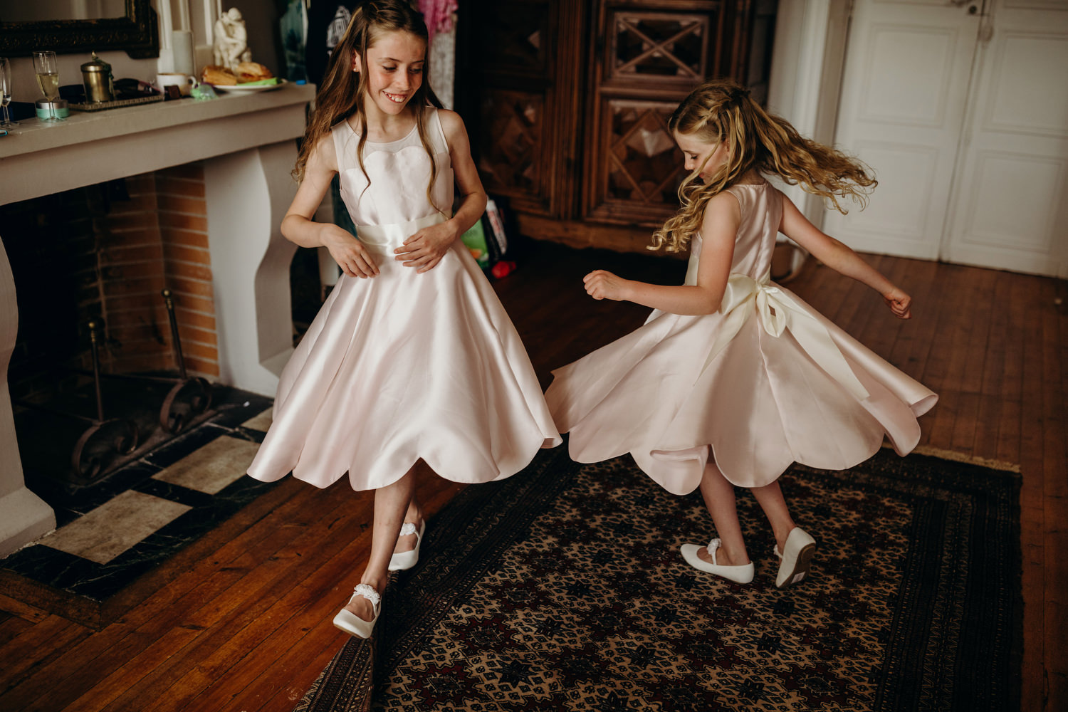 flower girls spin in their wedding dresses