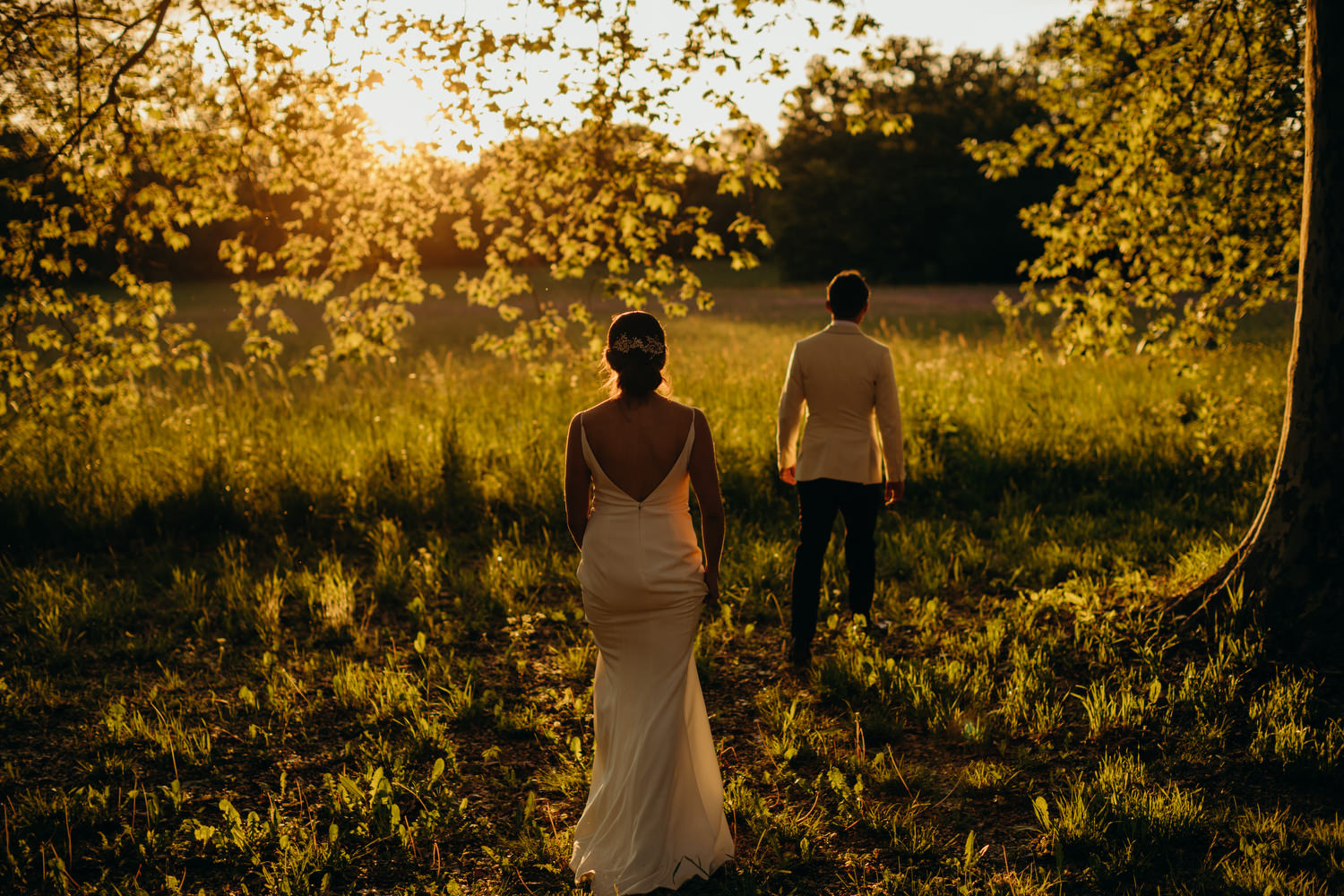 bride and groom walking at sunset at Chateau Le Mas de Montet 