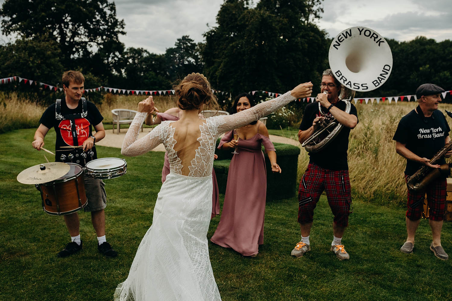 bride dances to brass band at wedding