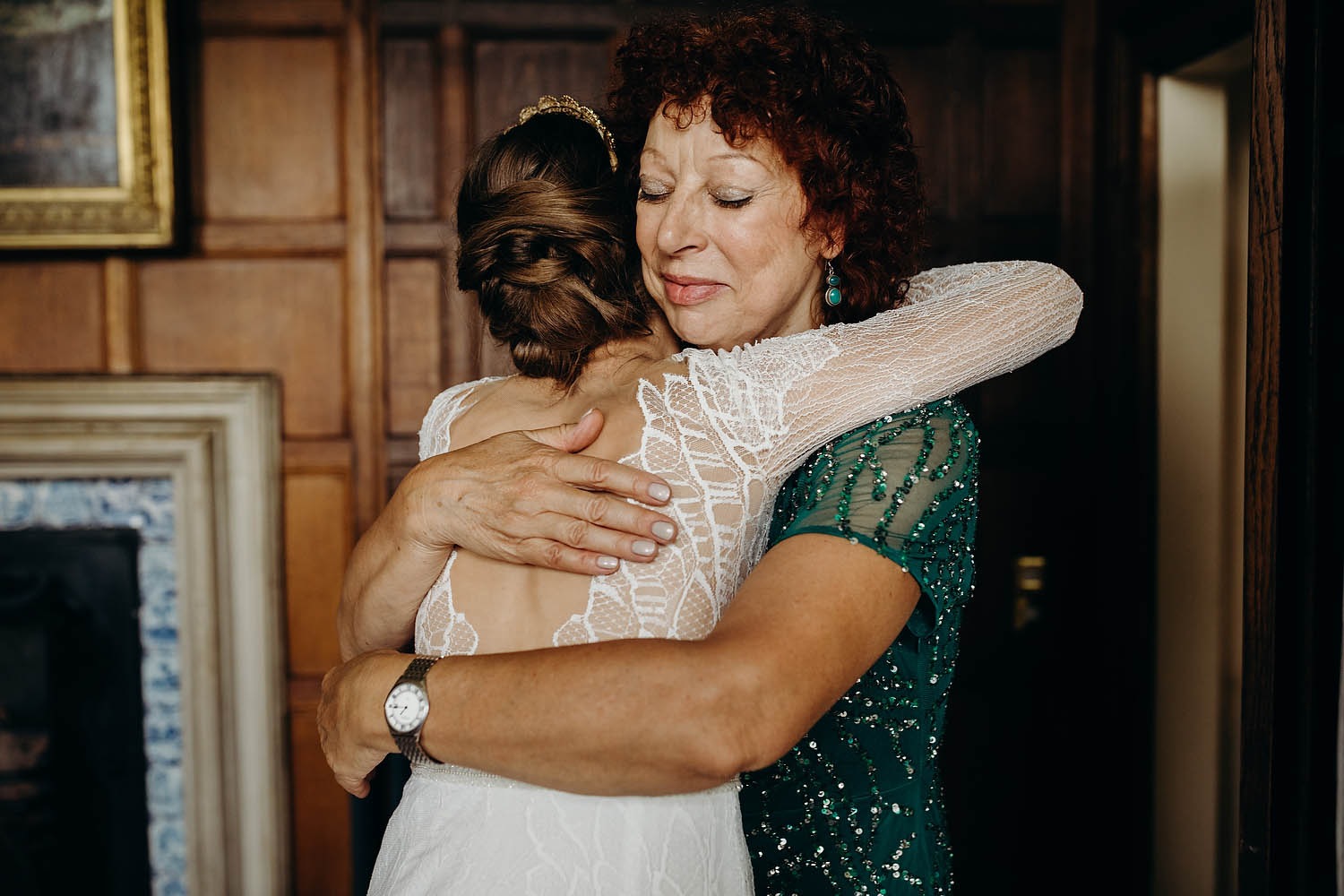 mother of bride hugs daughter before ceremony