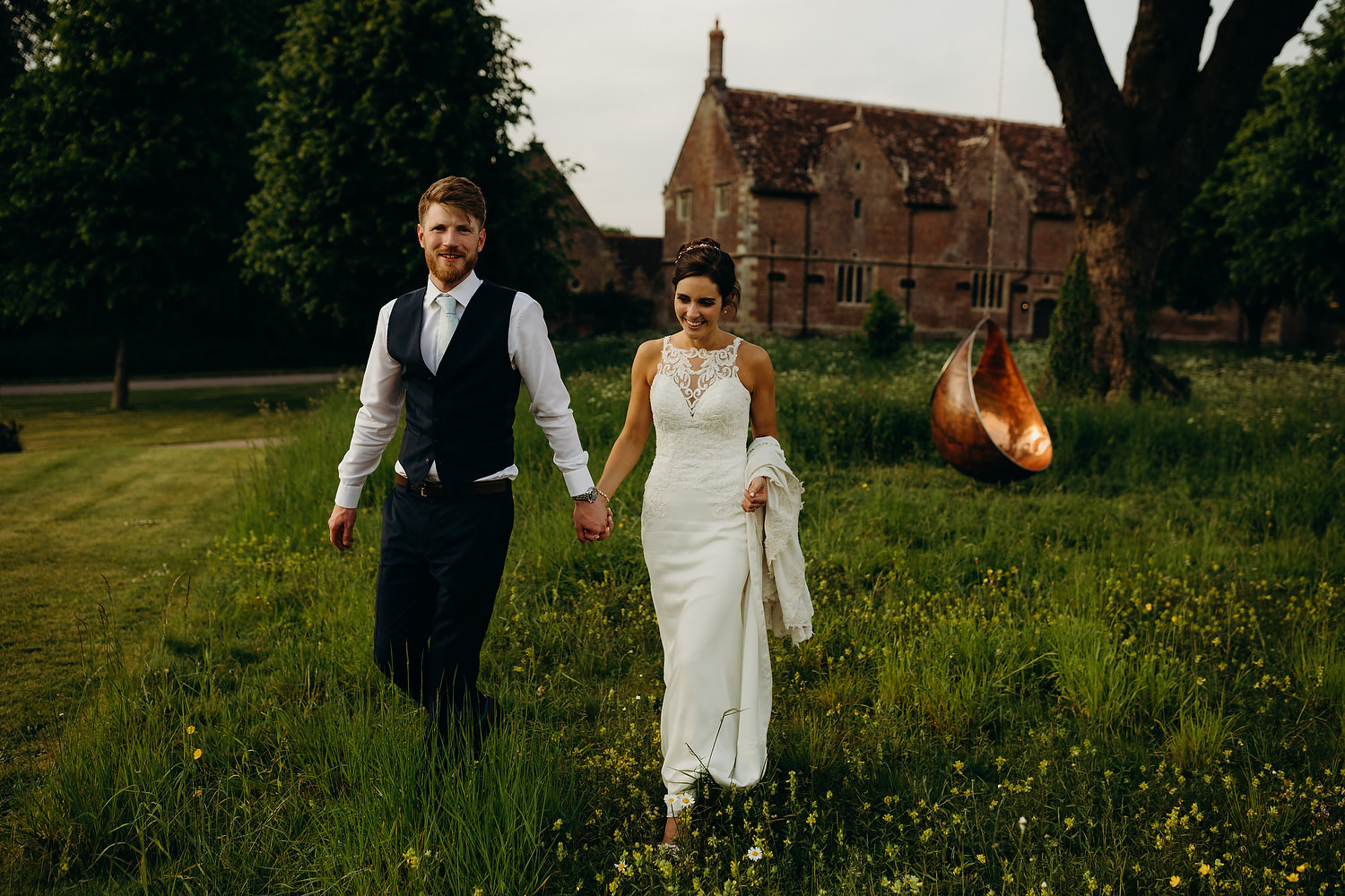 couple walk in gardens of st giles house at wedding