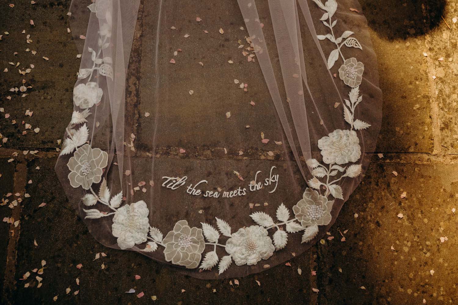 embroidery on wedding veil in dappled sunlight
