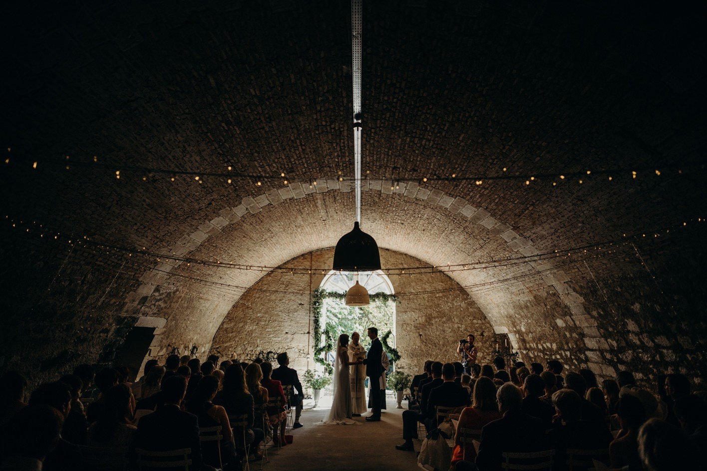 Cellar wedding ceremony with bride and groom facing each other