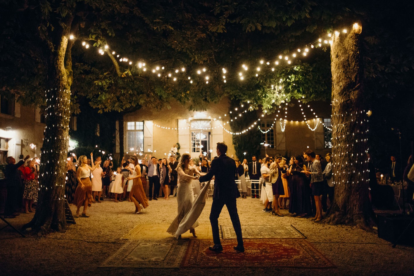 First dance lit up by festoon lighting at Chateau Lartigolle in South west France