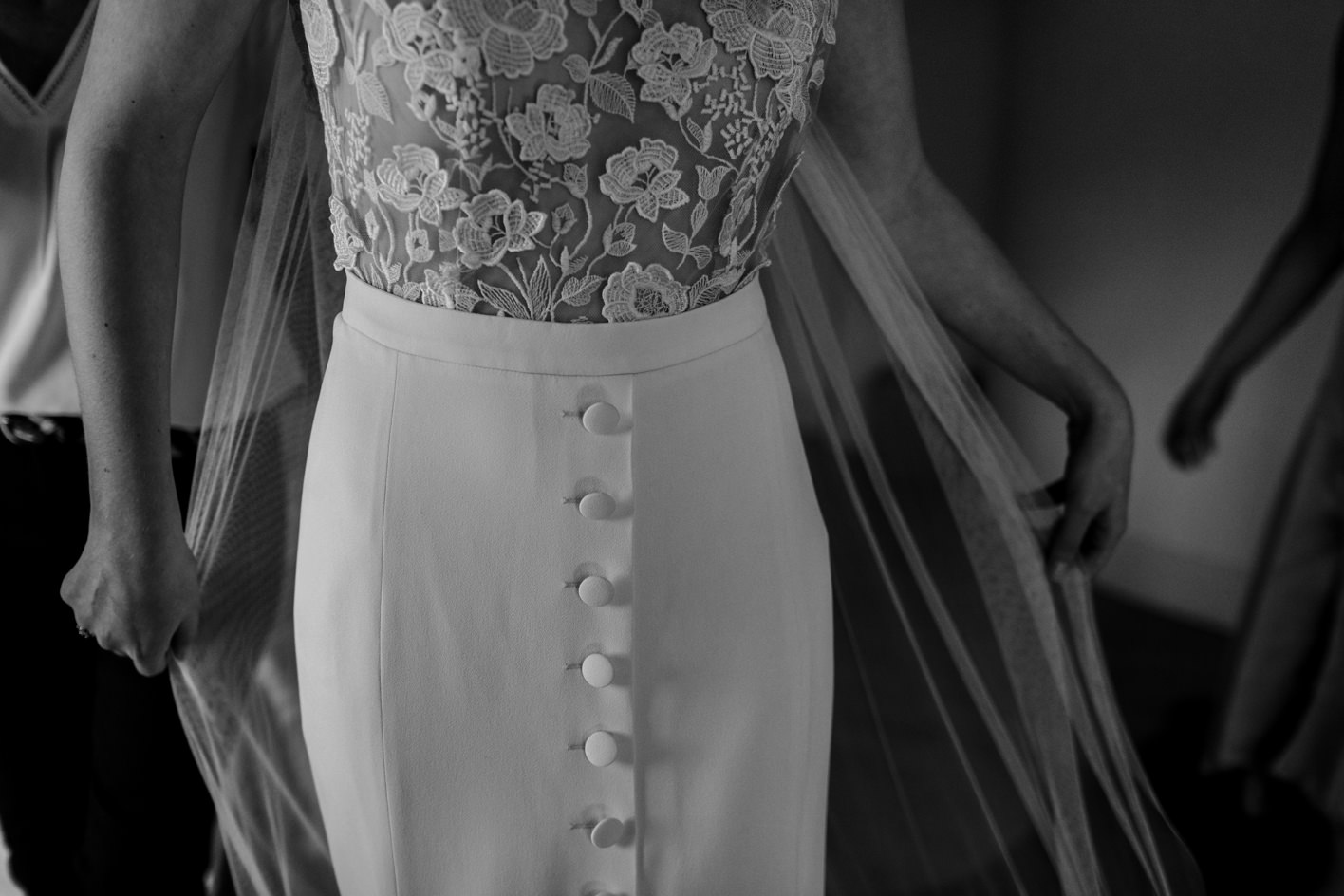 rime arodaky wedding dress as bride adjusts veil