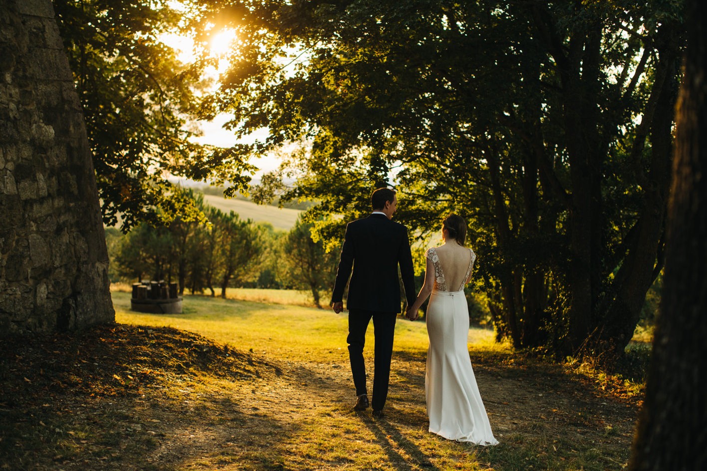 Sunset wooden backdrop of bride and groom walking away