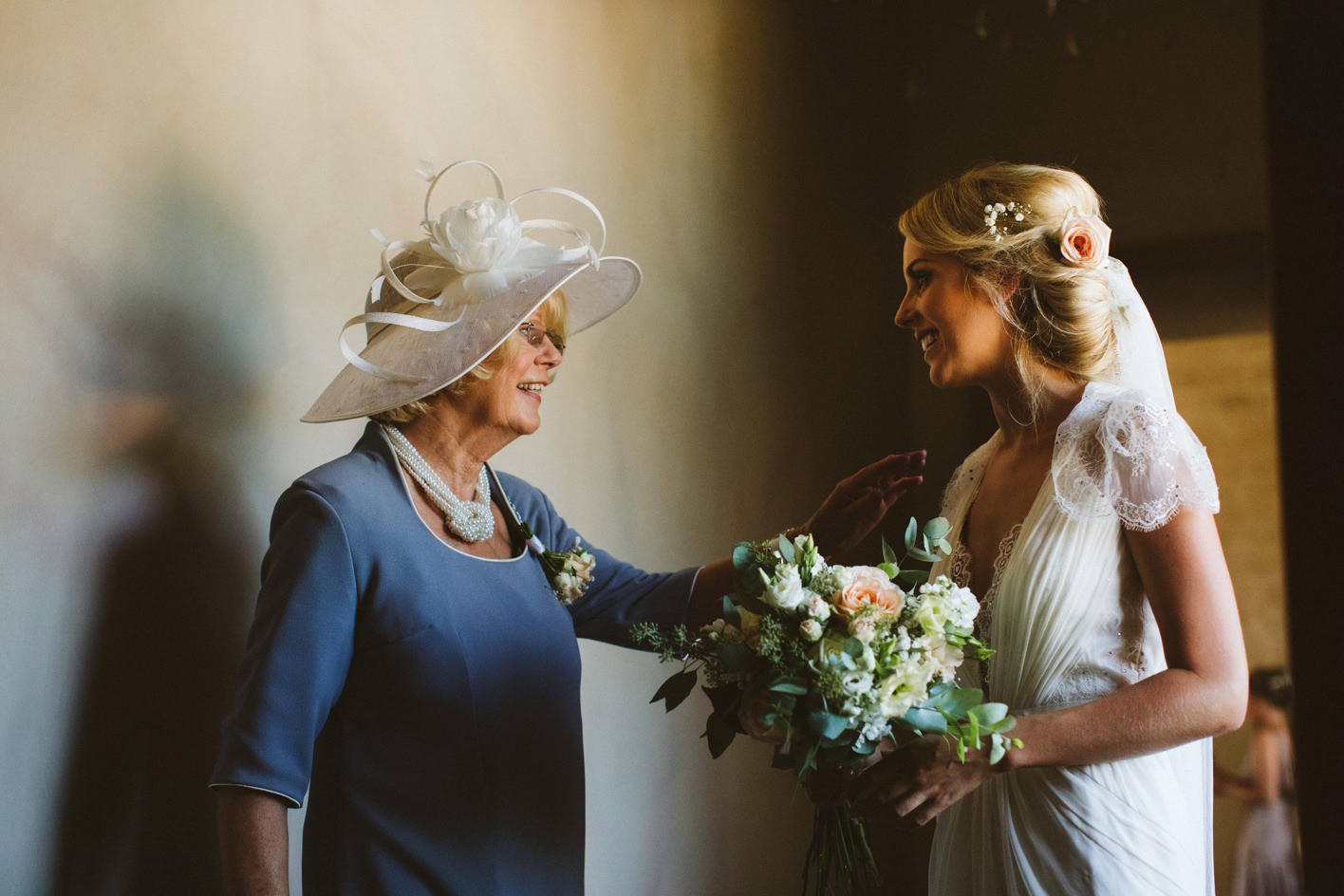 brides mother supporting daughter before her wedding ceremony