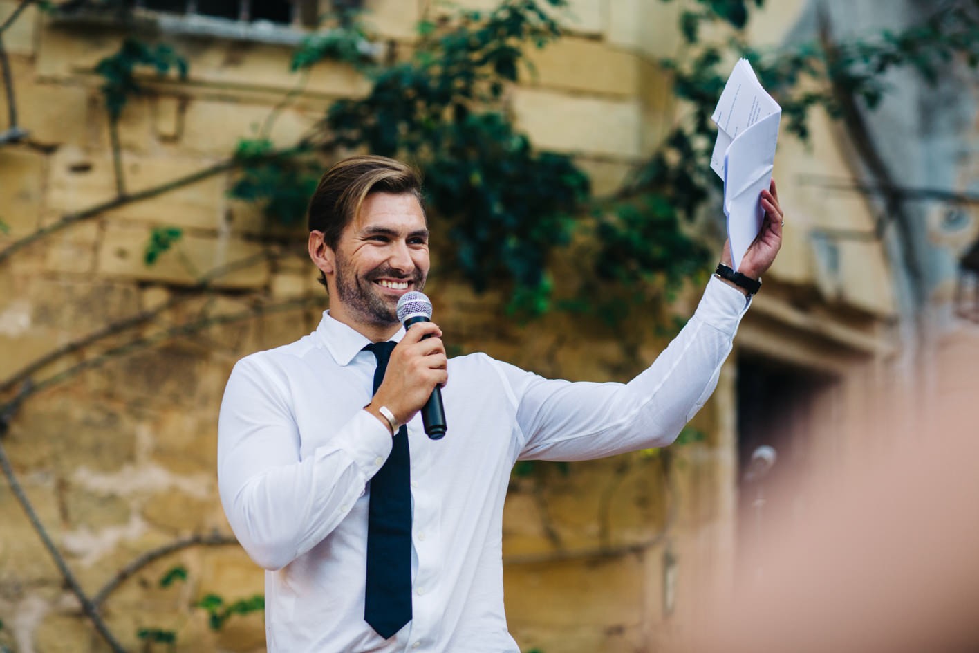 groom doing his speech on courtyard of chateau
