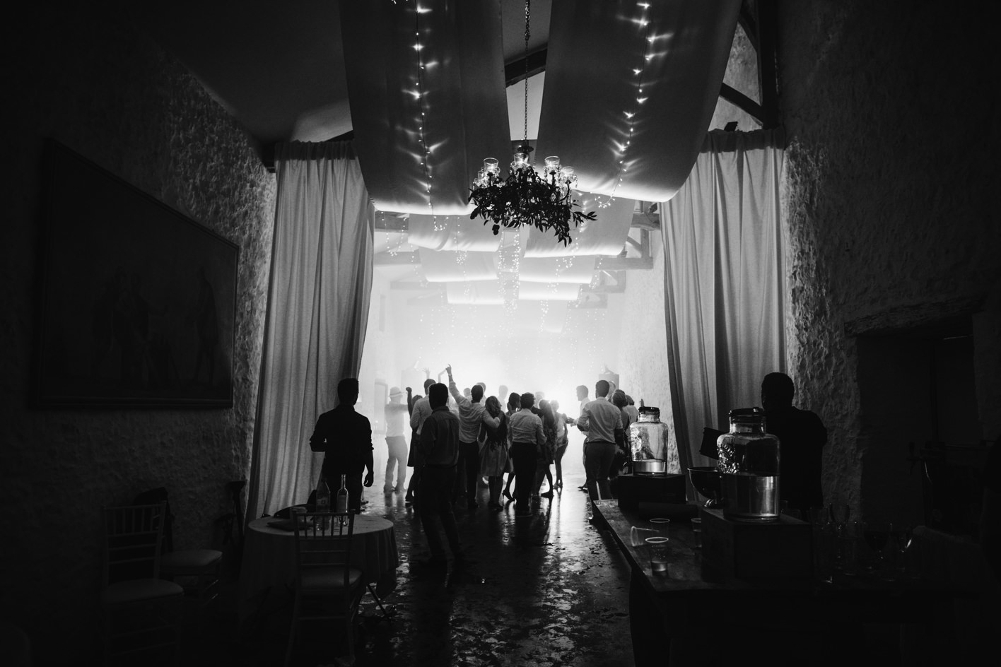 guests dancing as lighting creates moody atmosphere at wedding in France